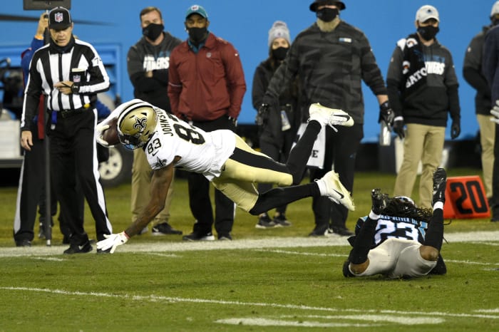 Jan 3, 2021; New Orleans Saints wide receiver Juwan Johnson (83) is tackled by Carolina Panthers cornerback Stantley Thomas-Oliver (23). Mandatory Credit: Bob Donnan-USA TODAY Sports